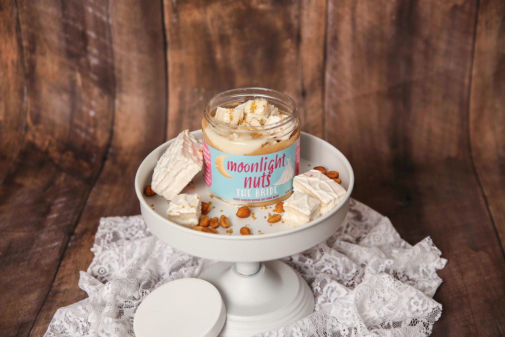 Jar of Carly’s Wedding Cake peanut butter with gold sugar topping
