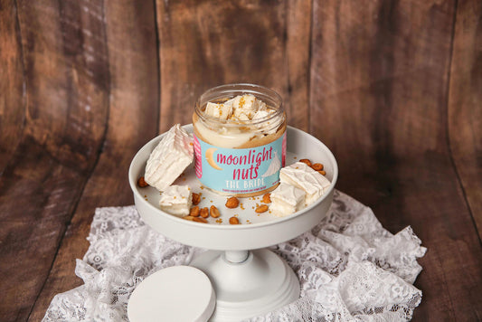 Jar of Carly’s Wedding Cake peanut butter with gold sugar topping