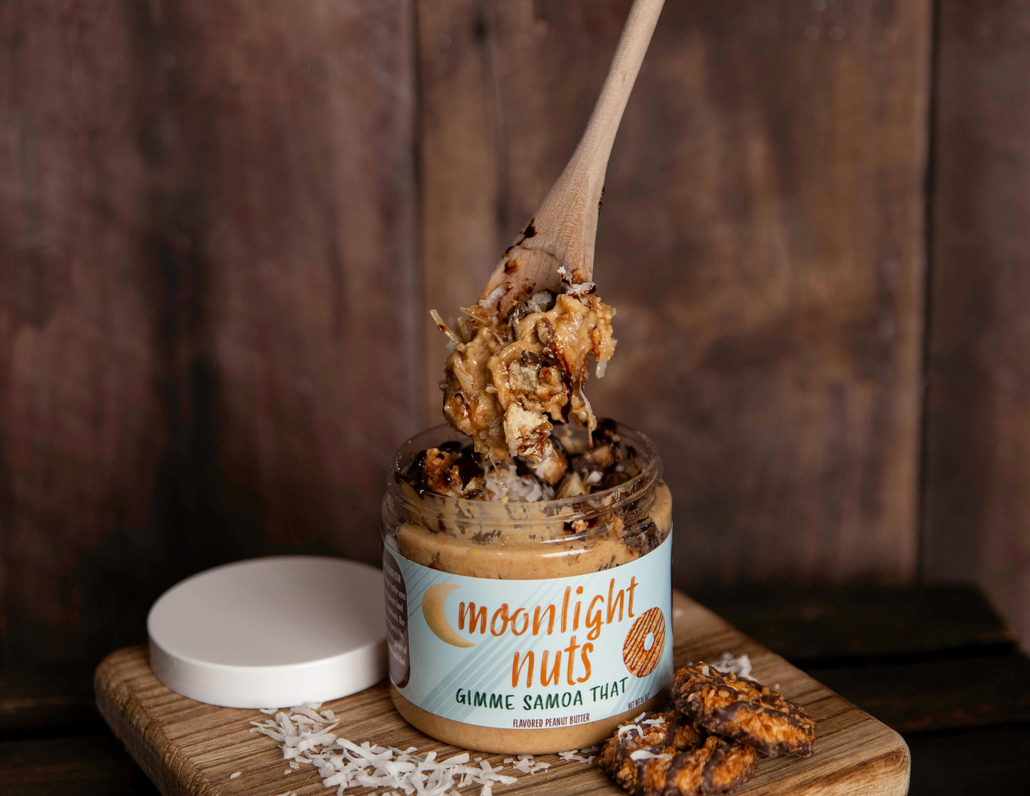 Spoonful of Gimme Samoa That peanut butter with coconut flakes, Samoa cookies, chocolate sauce, caramel sauce, and salted caramel sauce
