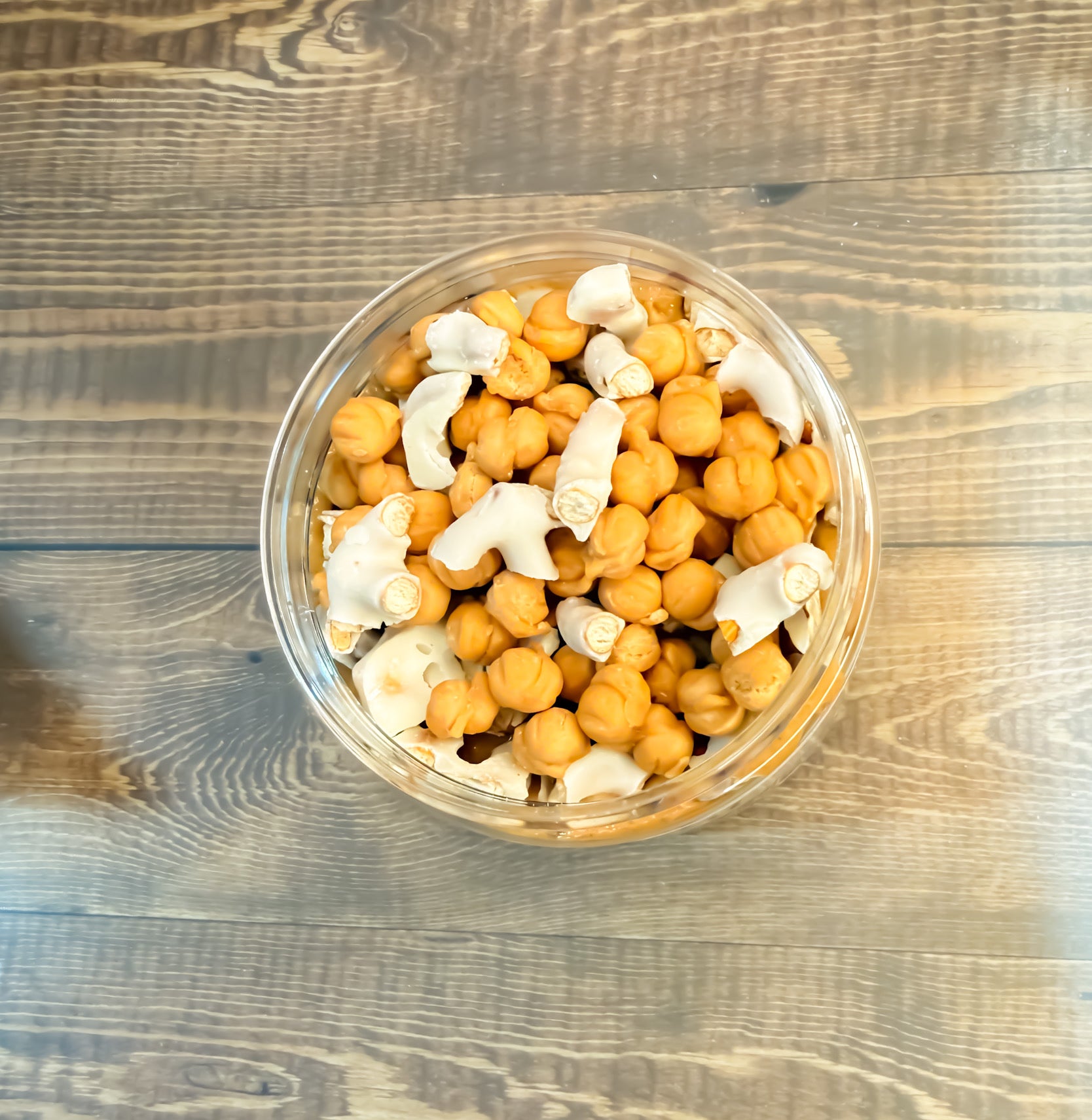 Caramel Me Crazy peanut butter top view showing the caramel bits, chocolate pretzels, and caramel sauce on the peanut butter.