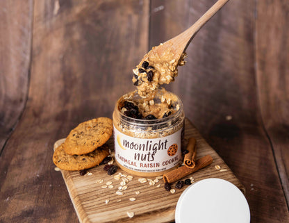 Jar of moonlight nuts oatmeal raisin cookie peanut butter showing a spoonful of the cinnamon peanut butter and toppings