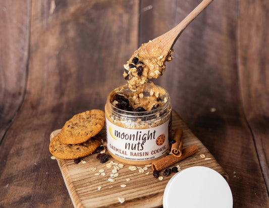 Jar of moonlight nuts oatmeal raisin cookie peanut butter showing a spoonful of the cinnamon peanut butter and toppings