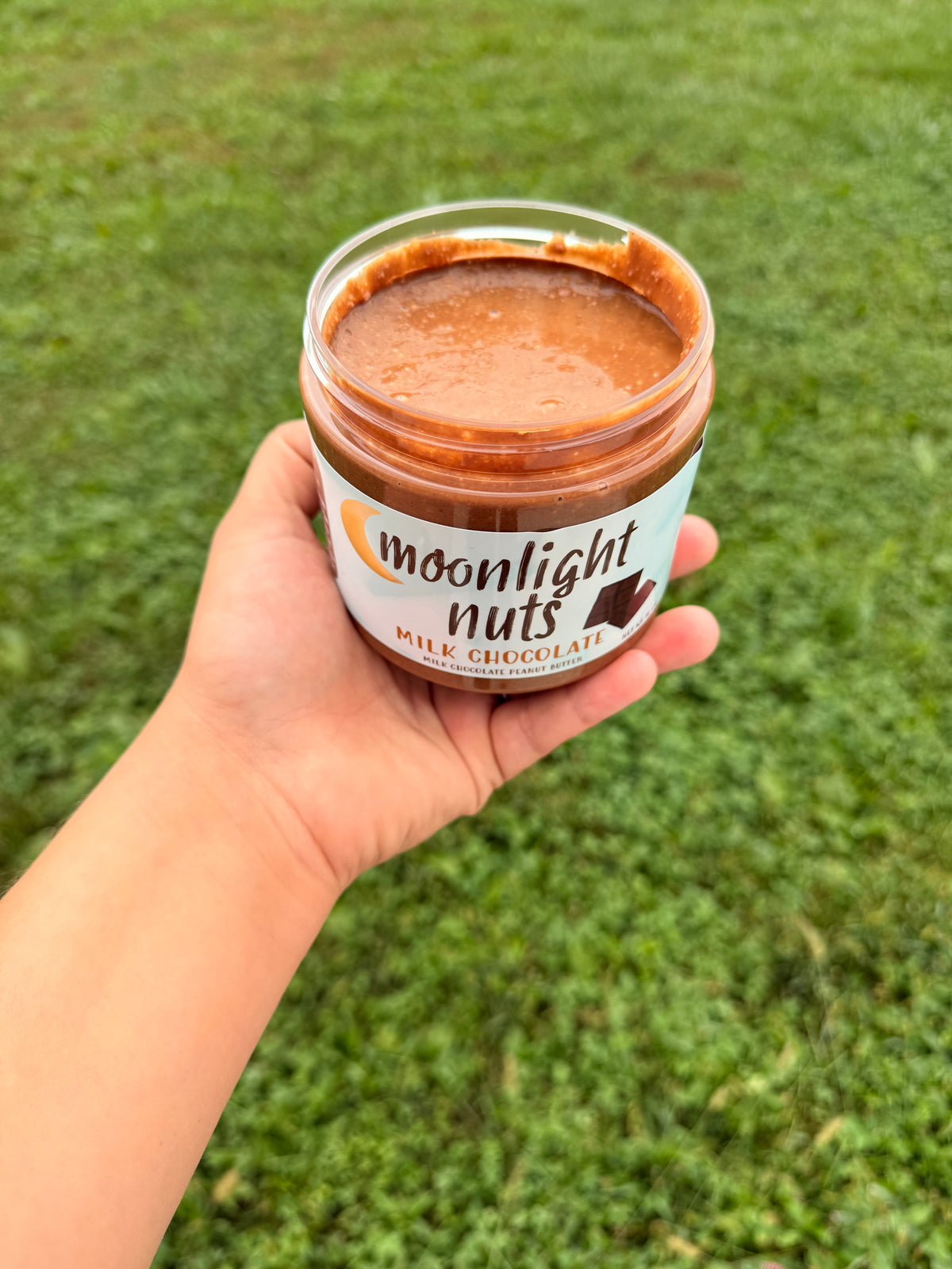 Open jar showing the milk chocolate peanut butter 