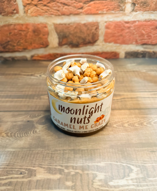 Jar of moonlight nuts “caramel me crazy” peanut butter showing some of the toppings