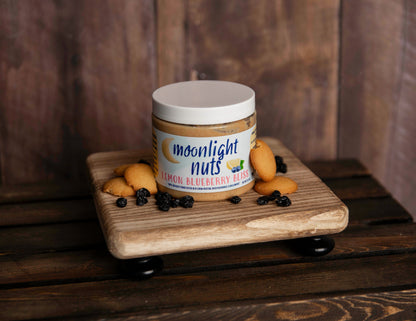 Jar of Moonlight Nuts Lemon Blueberry Bliss peanut butter with some of the toppings laid around it 