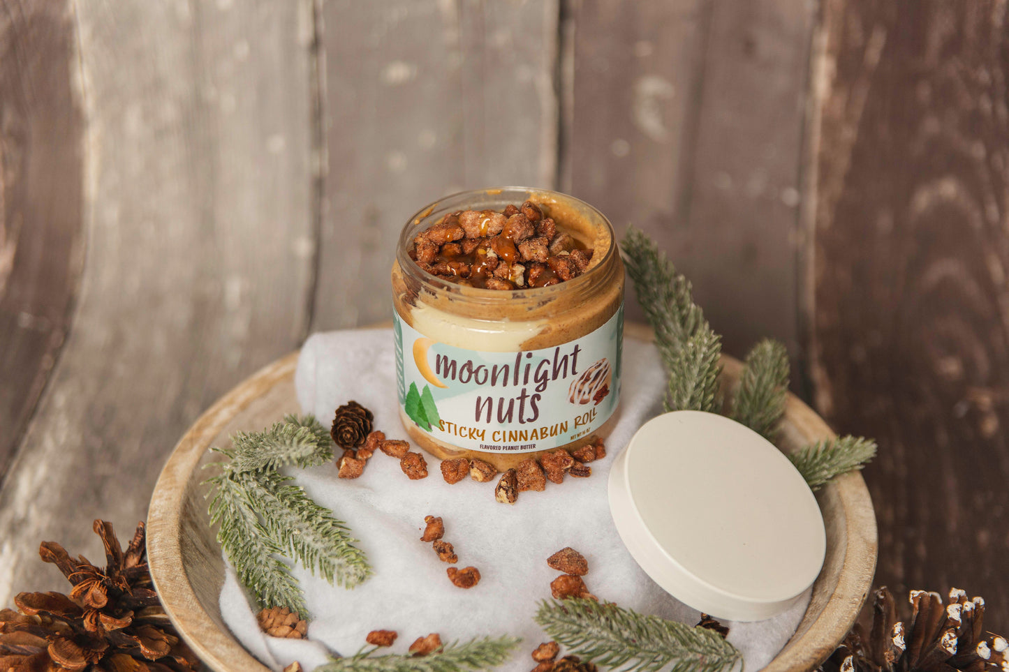 Jar of cinnamon roll moonlight nuts peanut butter and salted caramel sauce